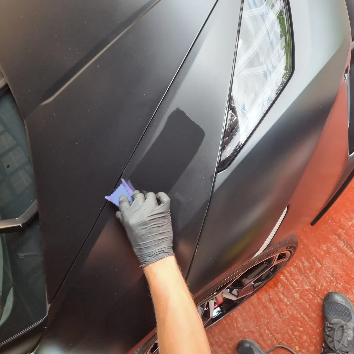 Close-up of Ceramic Coating being applied to a vehicle's bonnet showing its transparent protective qualities