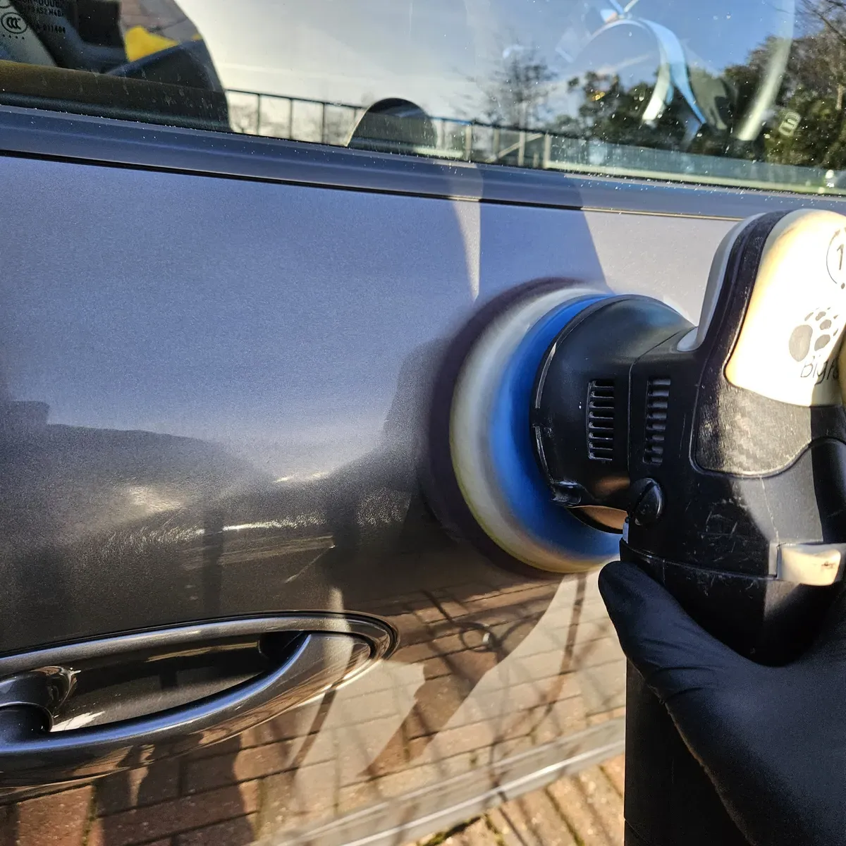 Close-up of Paint Correction being performed to a vehicle's door showing the process